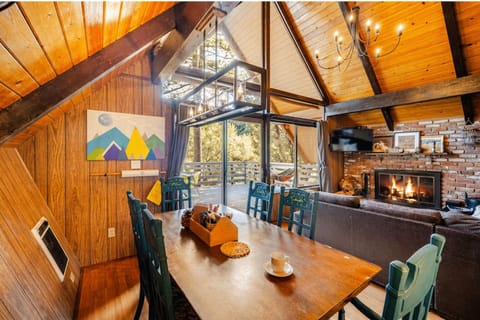 Living Room with Soaring Two Story Windows and Wood Burning Fireplace