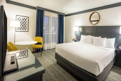 Unwind in a crisp king bed with cozy seating nook.