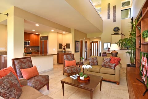 Warm, spacious living area with tropical decor and vaulted ceilings. KRV-1223
