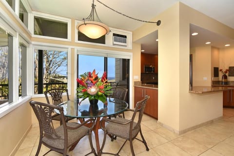 Cozy dining beside kitchen, framed by tropical floral arrangement views. KRV-1223