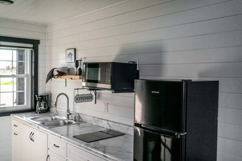The kitchenette is equipped with a microwave, refrigerator, drip coffee maker, and hot plate.