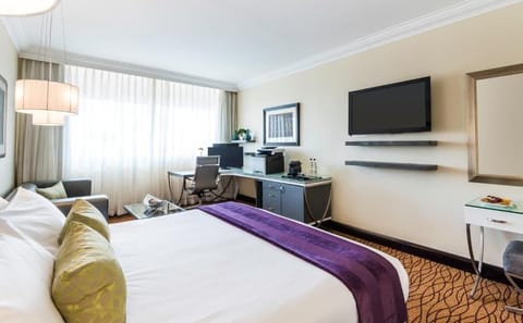 Settle in with a dedicated workspace and wall-mounted TV.