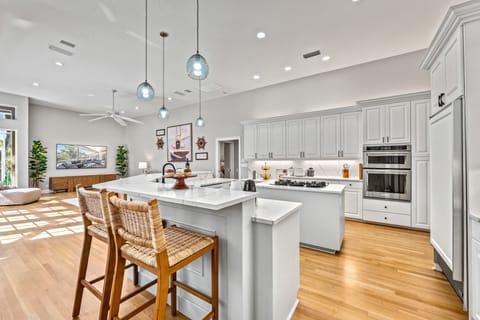 A spacious island invites gathering and conversation, perfect for meals and morning coffee alike.