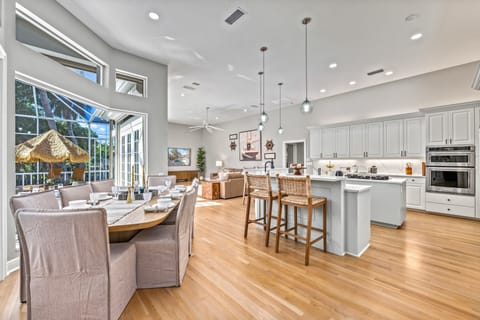 From the living room's edge, enjoy a seamless flow into the dining area, kitchen, and elegant den.