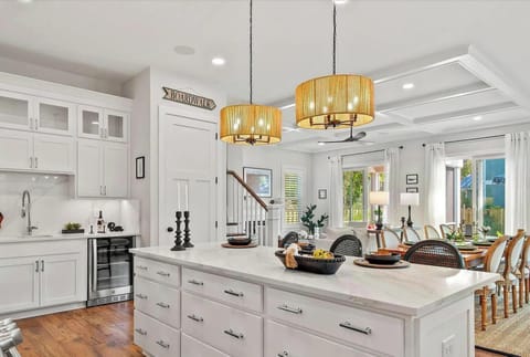 Photos shown represent a comparable new build and reflect the anticipated layout, finishes, and high-end coastal quality of this home.