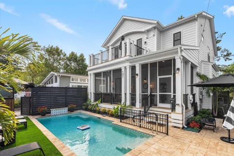 Enjoy your own private backyard oasis featuring a sparkling pool, screened porch, spacious upper balcony, and beautifully landscaped outdoor living spaces. The perfect place to relax, entertain, and create unforgettable beach vacation memories.