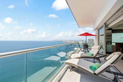 Private balcony with ocean views and outdoor furniture 