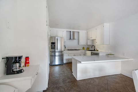 Spacious modern kitchen with large island, stainless steel appliances, and plenty of prep space.