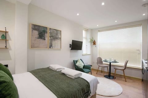 Comfortable bed beside lounge space