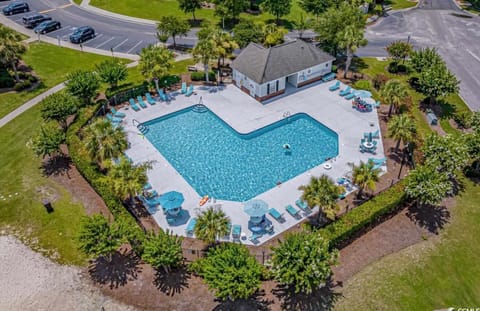 Ironwood pool access with bathrooms chairs tables, unbrellas and lounge chairs.