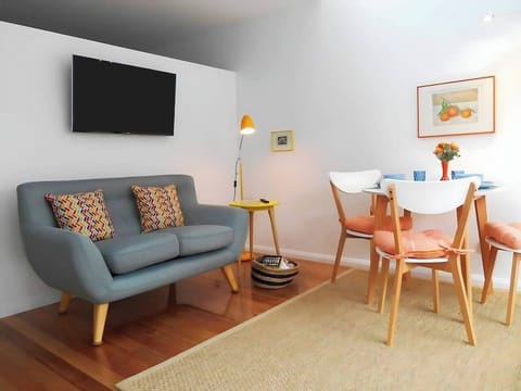 The cheery living and dining area offers a double sofabed and table to sit back and relax with a meal or a spot of TV