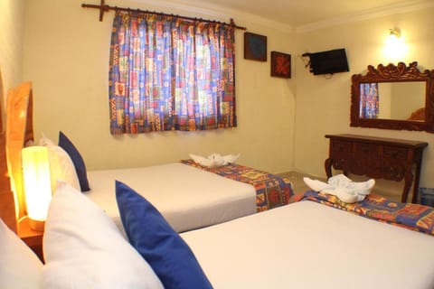 Recharge together in a cozy twin setup with warm ambiance.
