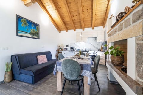 Open-plan living room with sofa, dining area, kitchen, WiFi internet, and satellite TV