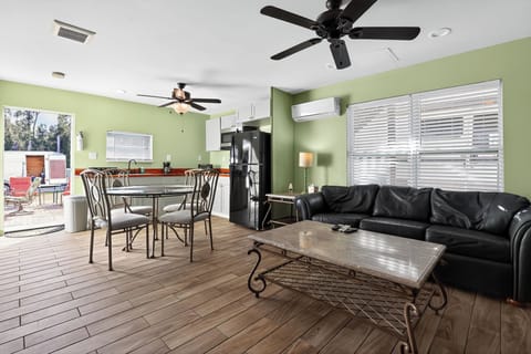 Spacious living room with full kitchenette, dining area, and comfy seating.