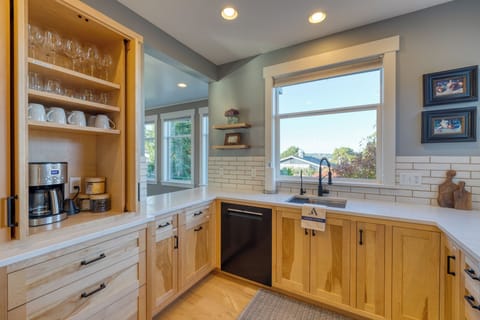 Main kitchen with wooden cabinetry and a window view.