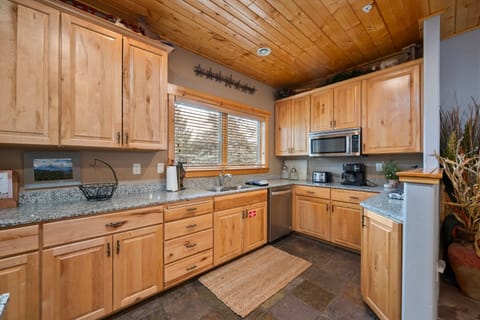 The large kitchen is fully equipped and includes a kitchen island with bar seating.
