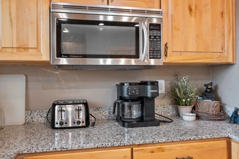 The large kitchen is fully equipped and includes a kitchen island with bar seating.