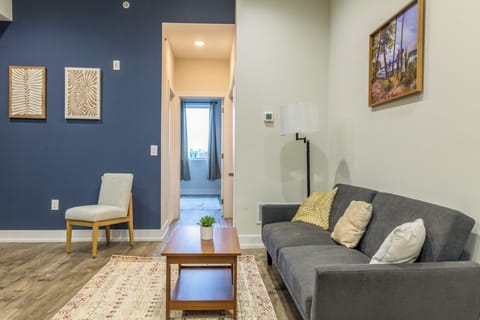 Cozy and inviting living room with comfortable seating, a smart TV, and plenty of natural light—perfect for relaxing or socializing.

