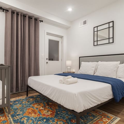 Quiet bedroom offering a comfortable queen bed, perfect for remote workers and travelers.