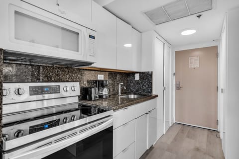 Cook with ease in this sleek vacation kitchen! Featuring granite counters, modern appliances, and everything you need for a comfy beachside stay.