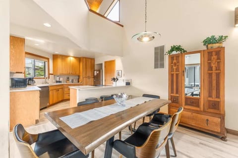 Long wooden table, open to living room & kitchen.