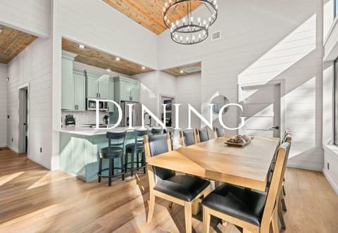 The dining area offers a warm, welcoming space to gather for shared meals, game nights, or long conversations that stretch into the evening.