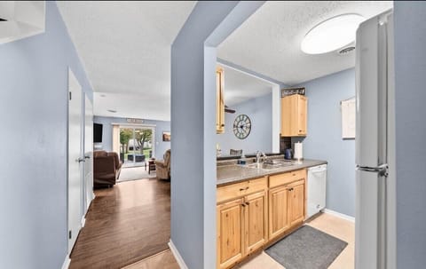 Full stocked kitchen with fridge, stove, microwave, and dishwasher.