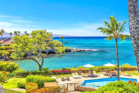 Breathtaking ocean view with turquoise waters, lush tropical landscaping, and a sparkling pool — the ultimate Hawaiian getaway setting. NAP-C37