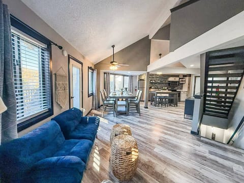 Open-concept living and dining space with vaulted ceilings.