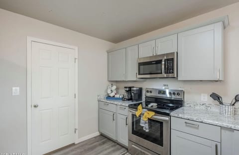 Two coffee makers, stove, oven and microwave.