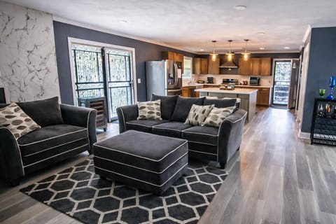 Sink into the plush velvet sofa and piped armchair—your cozy retreat. A versatile ottoman doubles as