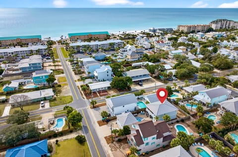 Just steps from the beach, Sun-Kissed is an 8-bedroom luxury villa that sleeps 22 and features a private heated pool, FREE golf cart, and a fun game room with air hockey and arcade games—perfect for unforgettable family vacations and group getaways!