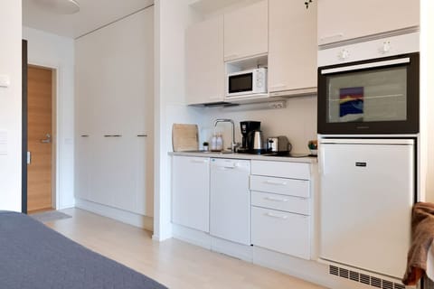 Sleek kitchen with modern appliances and clean, Nordic-inspired design.