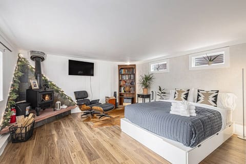 Queen bed for dreaming, lounge chair for getting lost in a book, smart TV for your favourite show.***Stylish fireplace included for looks only—please don’t use.***