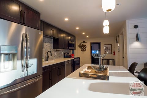 Modern, fully equipped kitchen featuring stainless steel appliances, ample counter space, and a large island centerpiece.