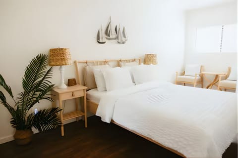 Bright bedroom with crisp white bedding and coastal décor accents.