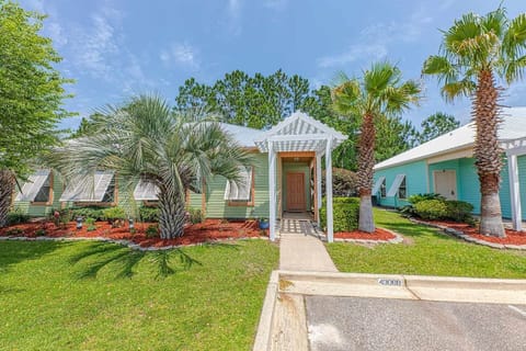 Charming Entrance: Step into paradise surrounded by vibrant greenery and tropical palm trees!