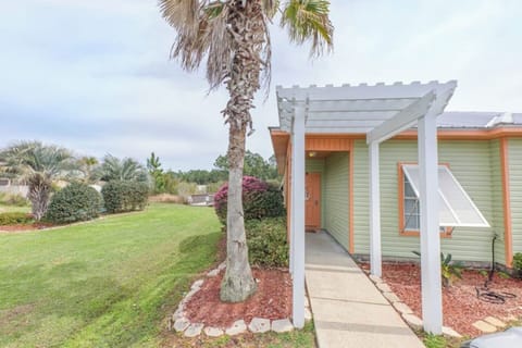 Entrance Oasis: Experience the charm of your beach getaway with vibrant landscaping and inviting walkways!