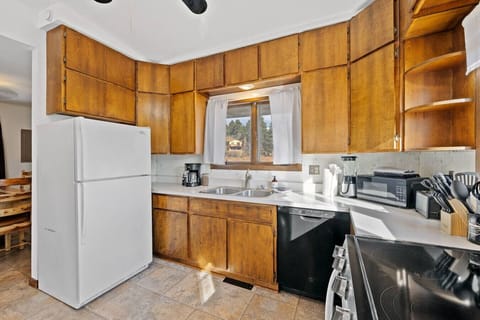 Fully equipped kitchen with kitchen appliances, cookware, and utensils — everything you need to prepare home-cooked meals.