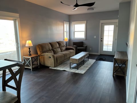 Large living room with a sofa that has 2 recliners.  Flat screen TV and WiFi