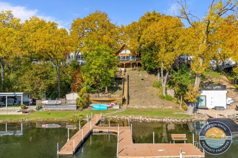 Your private lakefront retreat comes into view, offering direct access to the water and your own dock. Enjoy lake days with a canoe, two standup paddleboards, and a propane fire table for relaxing evenings by the shoreline.