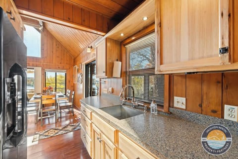 Open-concept comfort: A well-equipped kitchen flows seamlessly into the main living space, with stairs leading to the loft above. Designed for shared meals, easy mornings, and relaxed evenings under one roof.