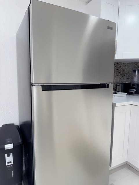 Step into your modern kitchen sanctuary with sleek stainless steel appliances and pristine white cabinetry. You'll love preparing meals with professional-grade amenities at your fingertips.