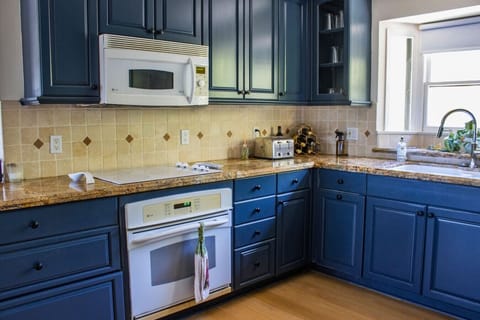 Fully equipped kitchen with modern appliances, ample counter space, and all the essentials for preparing meals, making it the perfect spot for cooking.