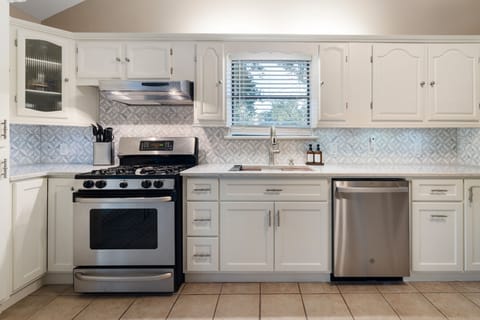 Gas stove with plenty of pots and pans. 