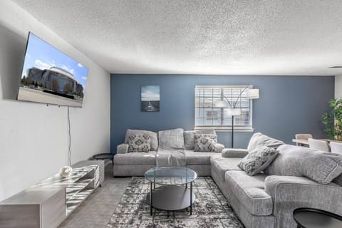 Spacious and inviting living area with comfortable seating and a smart TV, perfect for relaxing after exploring Arlington or attending events at AT&T Stadium.