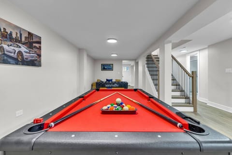 Versatile open space combining a game area, work desk, and comfortable living space