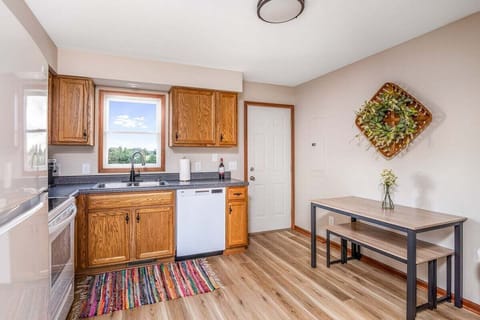There is a table and bench for sitting in the kitchen