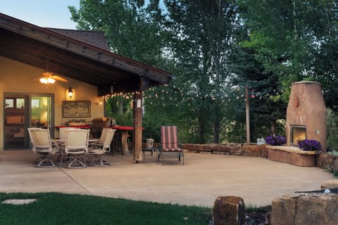 The outdoor deck at sunset is the place to be during warm months. String lights, gas fireplace, outdoor seating, and built-in gas grill all contribute to the perfect entertaining space.