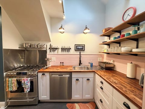 Kitchen with Gas Range, Dishwasher, and plenty of cookware